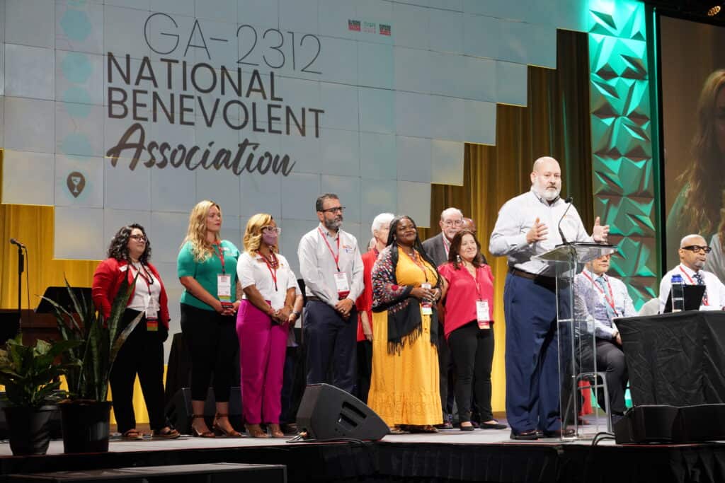 NBA staff gathered onstage during the business plenary session of the 2023 GA