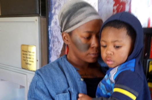 Adriana and her son at a motel for temporary housing.
