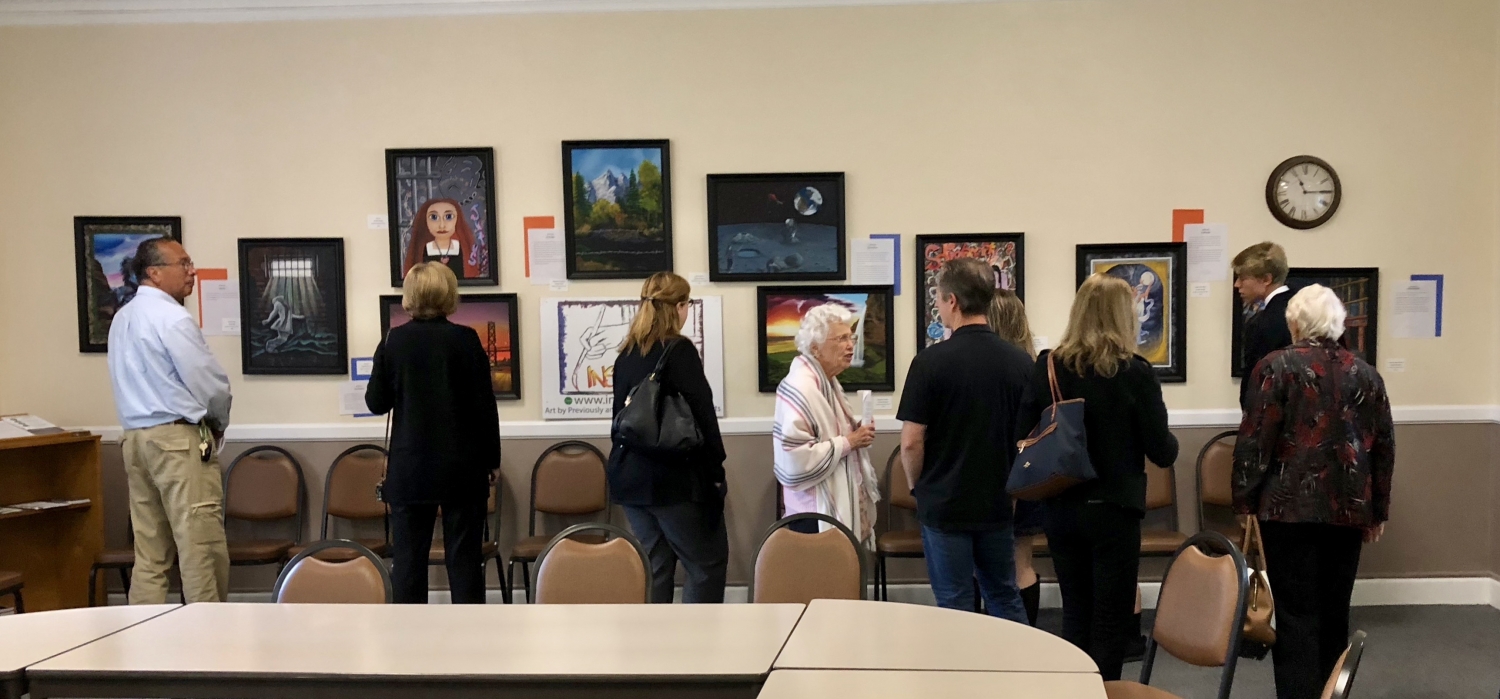 Visitors viewing and discussing the Claremont UCC exhibit of InsideOut Art, July 2018.