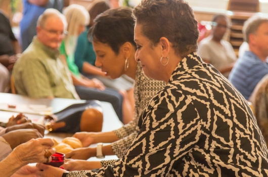 Rev. Terri Hord Owens and Rev. April Johnson serve communion at the Injustice Anywhere Update event in St. Louis on Sept. 27. Photo by Ron Lindsey.